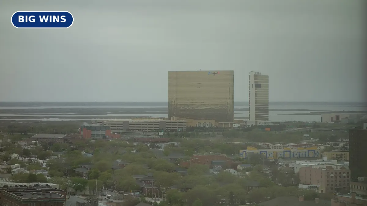 The gold Borgata hotel tower in Atlantic City seen from a distance under a blue sky
